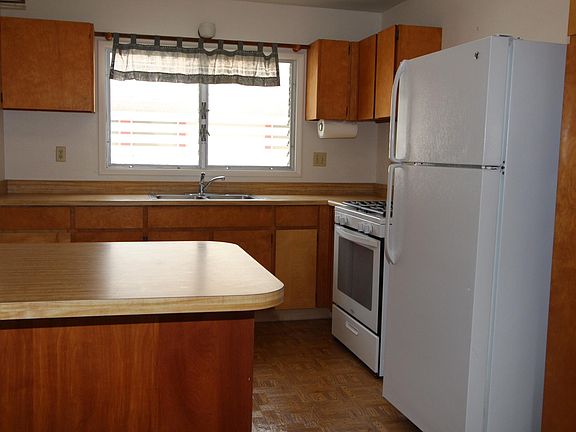 Kitchen with newer gas stove, refrigerator and disposal.  So