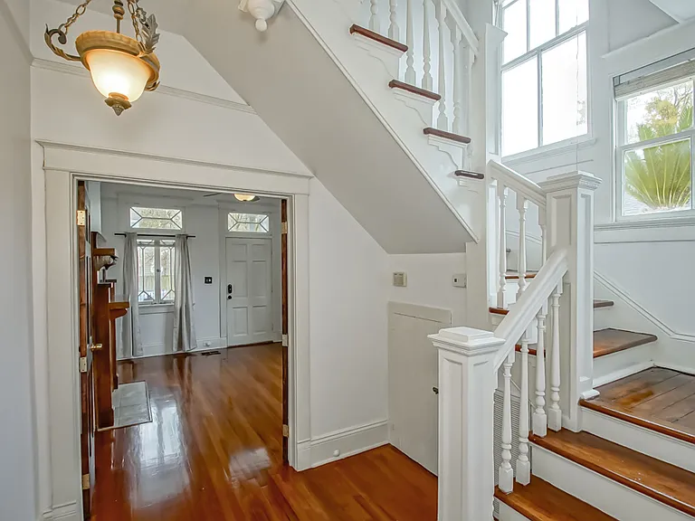 Staircase to upstairs, great natural light/windows and designer light fixture.