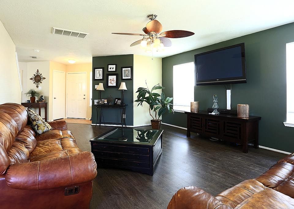 Inviting living room offers large space with laminate flooring.