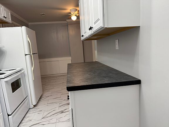Kitchen opens into dining area. Great for staying connected when family and friends are over.