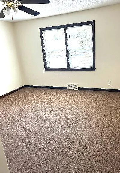 First floor master bedroom with mini split, ceiling fan, and large closet.