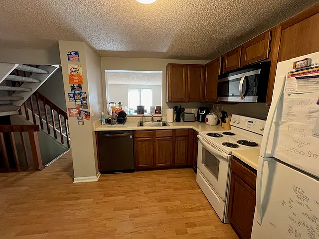 Kitchen w/ Serving Window Into Family Room