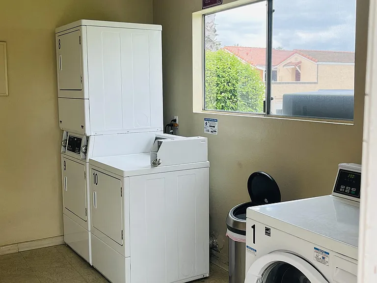 Laundry facilities in apartment building at Plaza Verde Apartments in Escondido, California.
