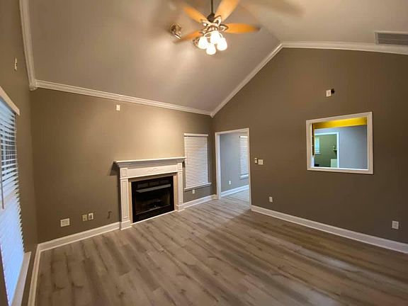 Living room with high vaulted ceiling and gas ventless fireplace.. looking into the kitchen