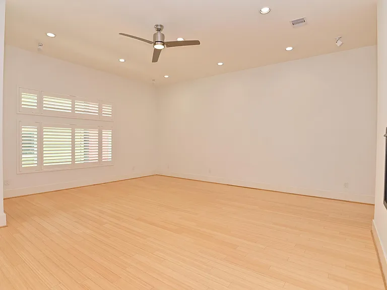 Living room with custom shutters. Speakers in ceiling for your use.