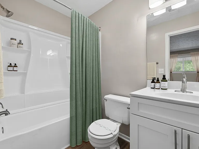 Updated bathroom featuring a tub-shower combo and modern vanity