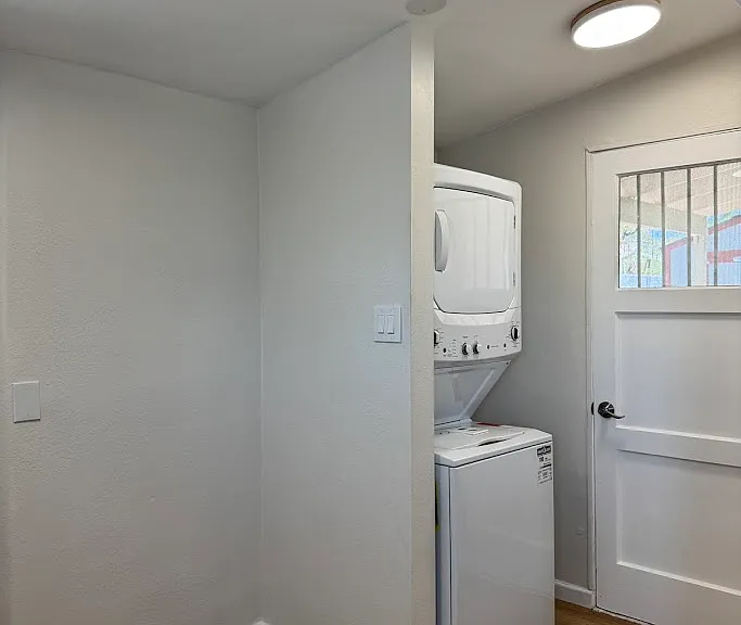 Washer/Dryer and door to the rear yard and covered patio