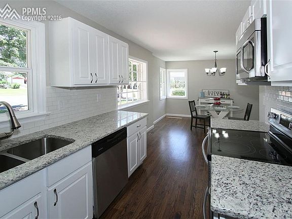 Kitchen with new granite counters, hardwood flooring and Frigidaire stainless st