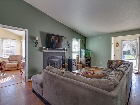 Open great room with laminate floors and elevated ceilings is great for hanging out or entertaining.