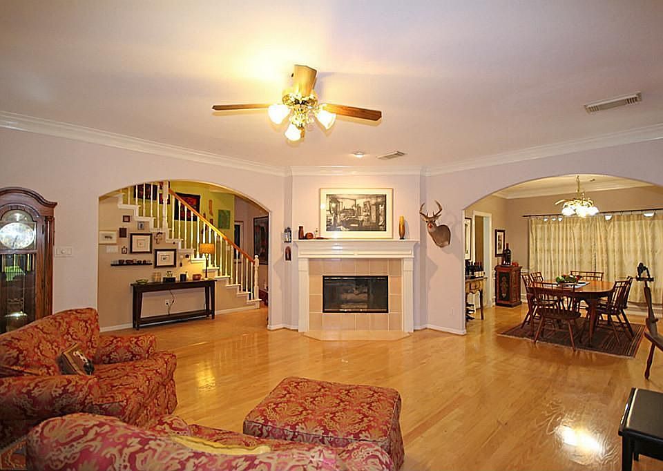 The over-sized Family Room features neutral wall tones that highlight the crown molding, gleaming wood floors and a gas burning fireplace!