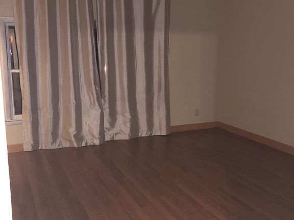 Huge living room with large windows and walk-in storage atta
