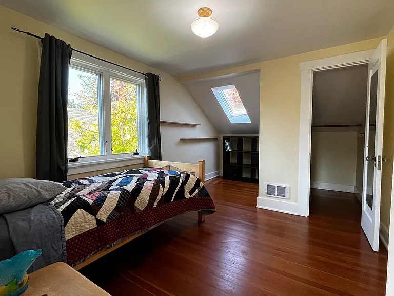 Walk-in closet with dresser inside on the left.