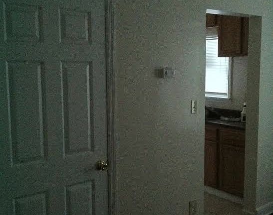 Dining room going into the kitchen and upstairs bedroom door