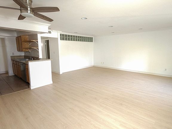 Open layout with new laminate flooring and seamless flow between living and dining areas.