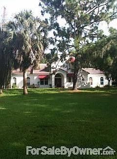 Front View : This home sits beautifully in the middle of almost 2 acres with large trees.