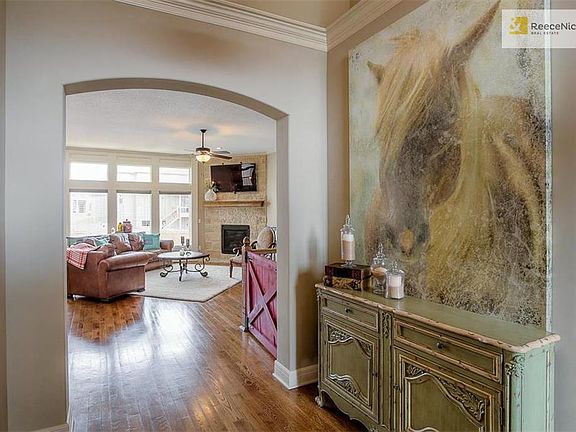 Arched entries, and loads of windows with wood detail enhance the welcome, open feeling of this gorgeous home.