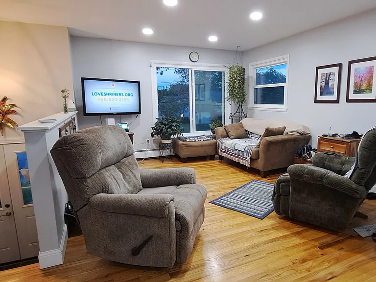 Upstairs living room that is open to the kitchen. Hard wood floors in all upstairs except for vinyl in kitchen.