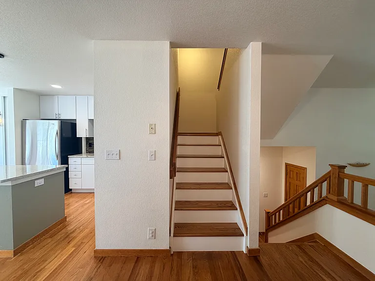 The main level features gleaming hardwood floors