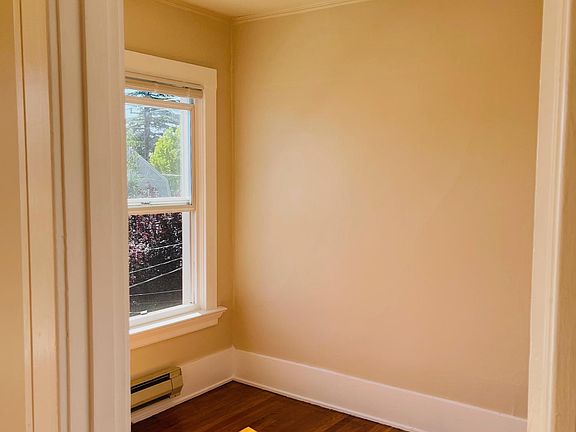 Front bedroom or home office with hardwood floors and natural light