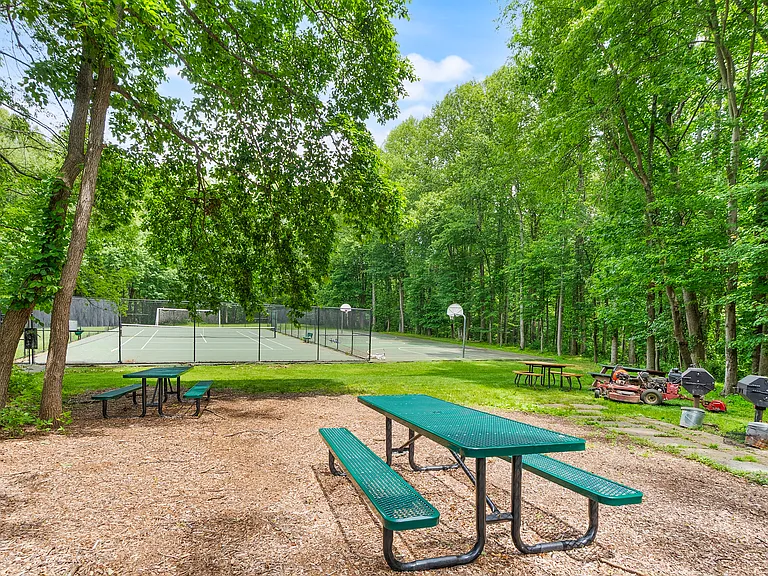 Picnic tables, grills, basketball and tennis/pickleball courts. Paths lead down into the Lake Fairfax Park trail system.