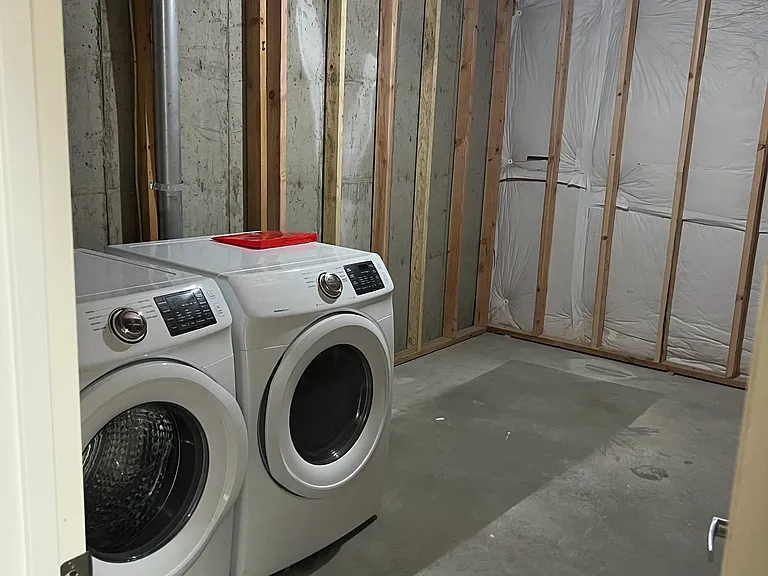 Washer and Dryer in extra storage room in basement.