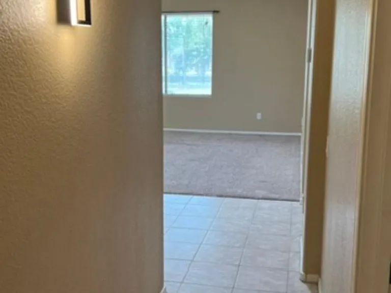 inside first floor hallway leading to bedroom, full bathroom, family room and master bedroom
