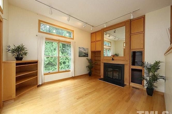 High ceilings in sunken Living room with fireplace and more custom cabinetry