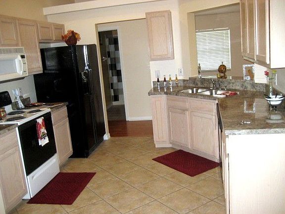 Gray Marble appearance counter tops, wood cabinets and appliances included