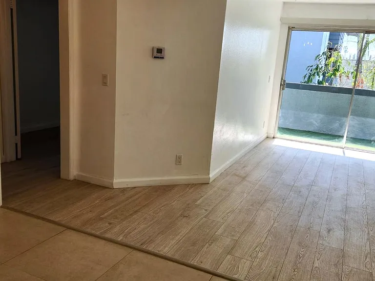 Spacious living room with large private balcony