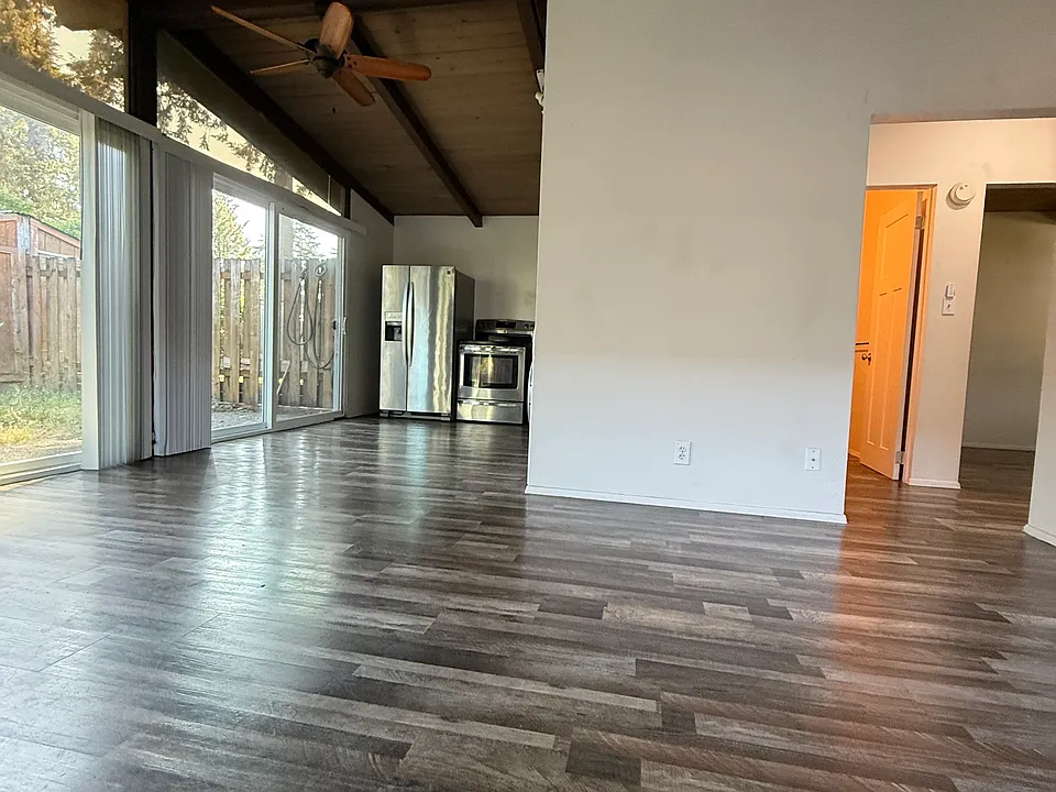 Upon entering, you see the two large glass sliding doors leading to the kitchen area. The doorway to right leads to bathroom and bedrooms