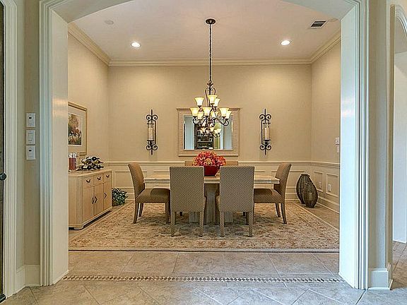 Dining room has 20x20 Tosca beige tile floor and the walls have a wainscot and chair rail