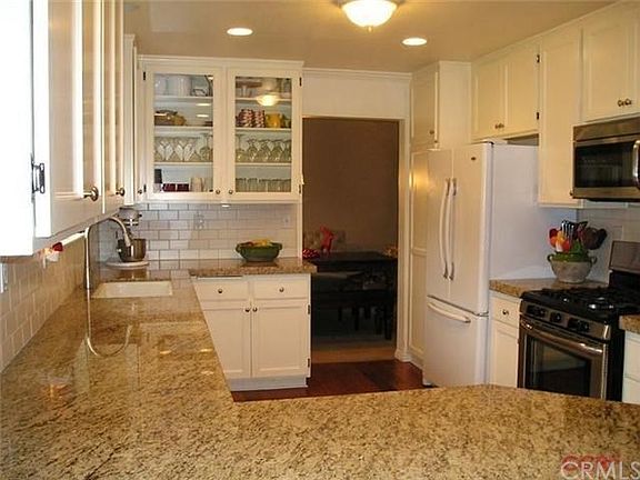 Kitchen with granite counter tops and stainless steel oven, microwave and dishwasher. Notice the big sink too!