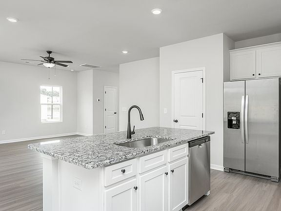 The kitchen has a granite island.