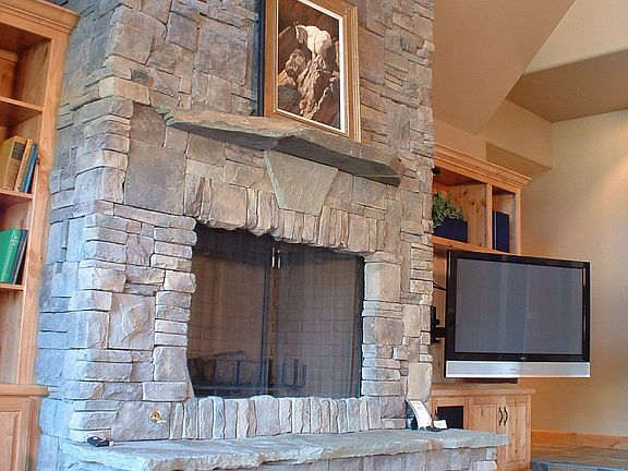 fireplace in great room with hidden wood storage under hearth