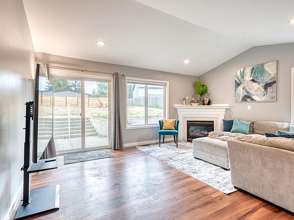 Upstairs living room with 65" HDTV and sliding patio door to the fully fenced backyard