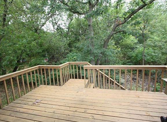 Large deck off the informal dining area to entertain on and enjoy the  beautiful view of all the trees in the backyard.