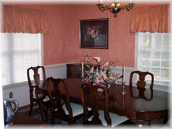 Formal dining room with hardwood floors and chair rail