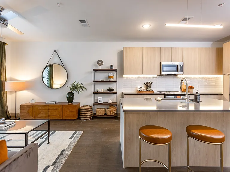 Sleek kitchen design flows into a bright living space.