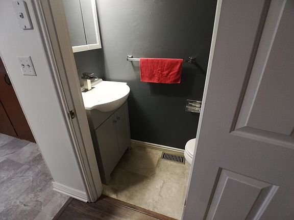 New flooring, vanity and sink in half bath