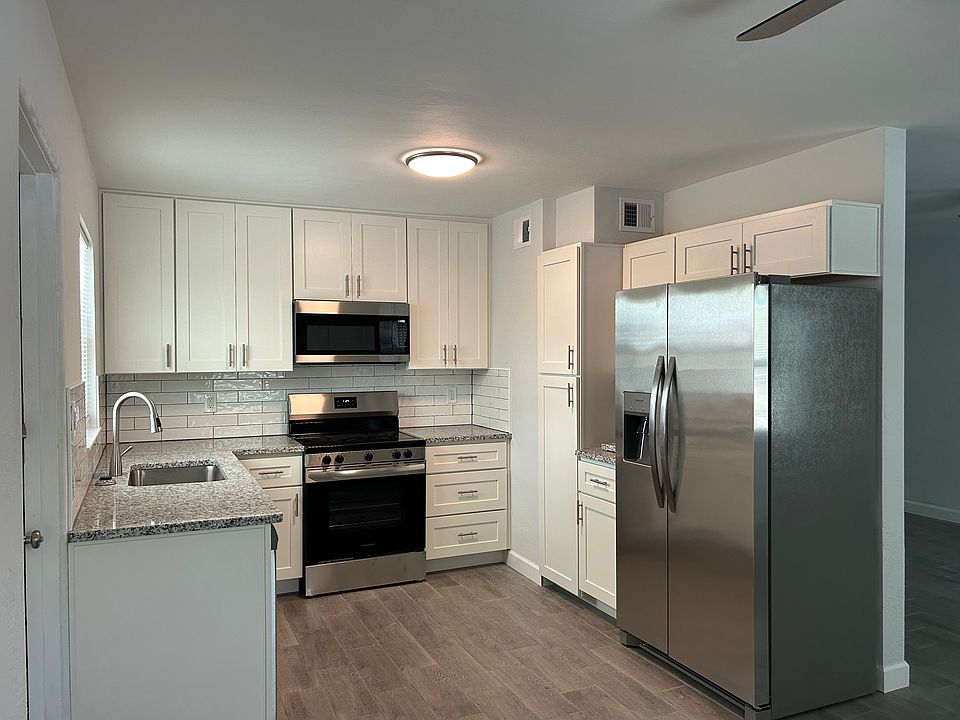 Newly updated bright kitchen with granite counter tops, new counter depth refrigerator with icemaker, new above the range microwave, new glass top stove, new dishwasher.