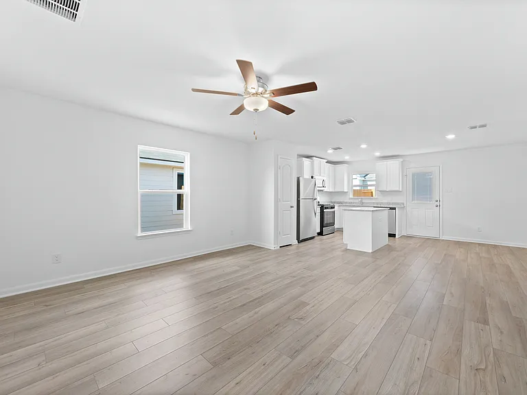 Spacious family room with an adjoining kitchen.