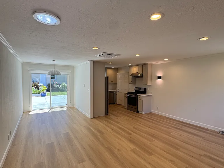 Living room facing dining room, patio and kitchen