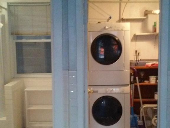 Full size washer and dryer in separate large laundry/furnace room.