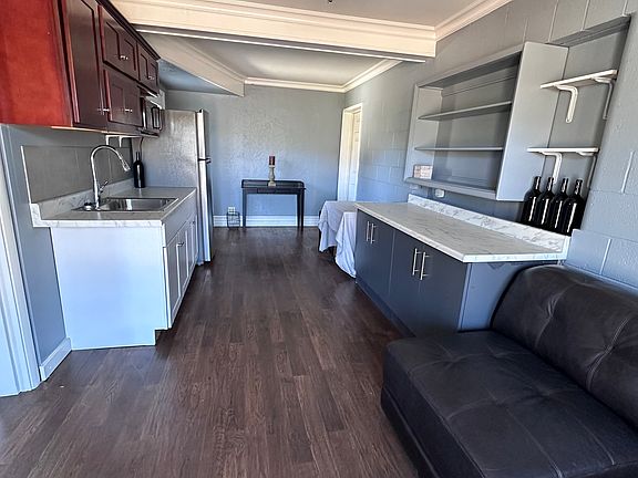 Kitchenette and dining area. Large countertops, cabinets and shelving.