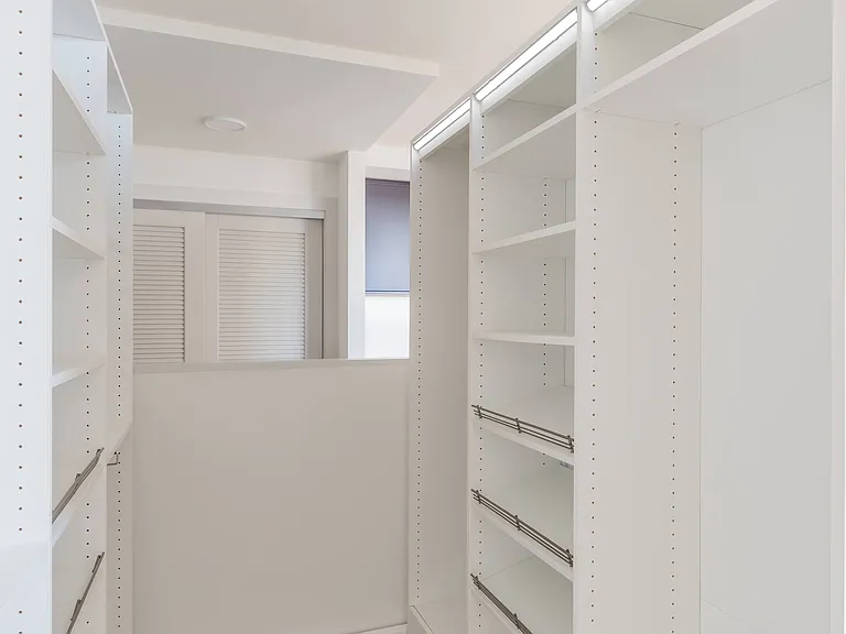 The Ori Pocket Closet tucks away neatly, opening up to reveal organized shelving and hanging space exactly when you need it.