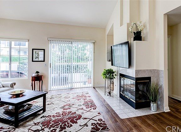 Front door enters at Living Room - with beautiful flooring and cathedral ceilings not always available in downstairs units.