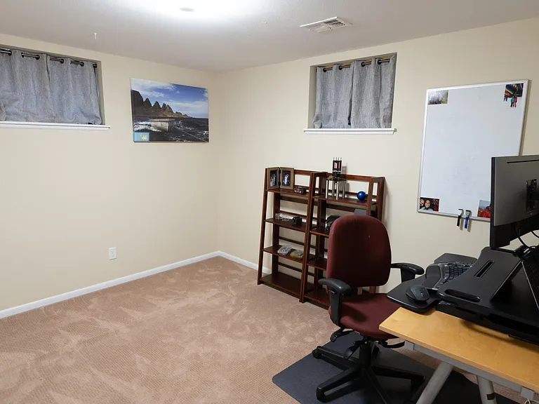 Looking north-east in the additional room, showing two windows facing north and east.