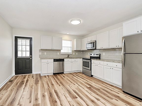 Kitchen with stainless steel appliances and granite countertops.