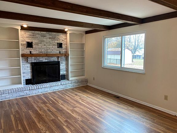 Large open concept living room with beautiful fireplace and lots of natural light.