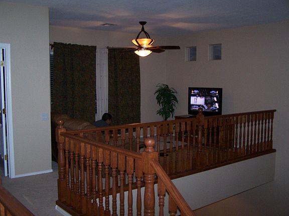 Beautiful staircase and rail that leads to a  loft for office or game room